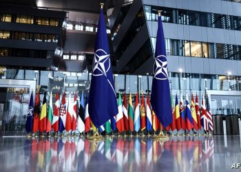 A photograph taken on February 16, 2022 shows the flags of the North Atlantic Treaty Organization (NATO) prior to the Meeting of NATO Ministers of Defence at the NATO Headquarter in Brussels. (Photo by Kenzo TRIBOUILLARD / AFP)