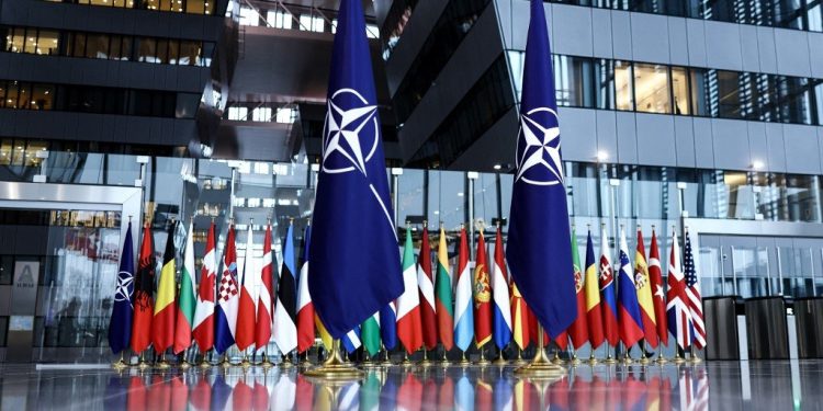 A photograph taken on February 16, 2022 shows the flags of the North Atlantic Treaty Organization (NATO) prior to the Meeting of NATO Ministers of Defence at the NATO Headquarter in Brussels. (Photo by Kenzo TRIBOUILLARD / AFP)