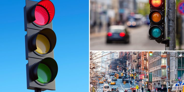 Red traffic light against sky